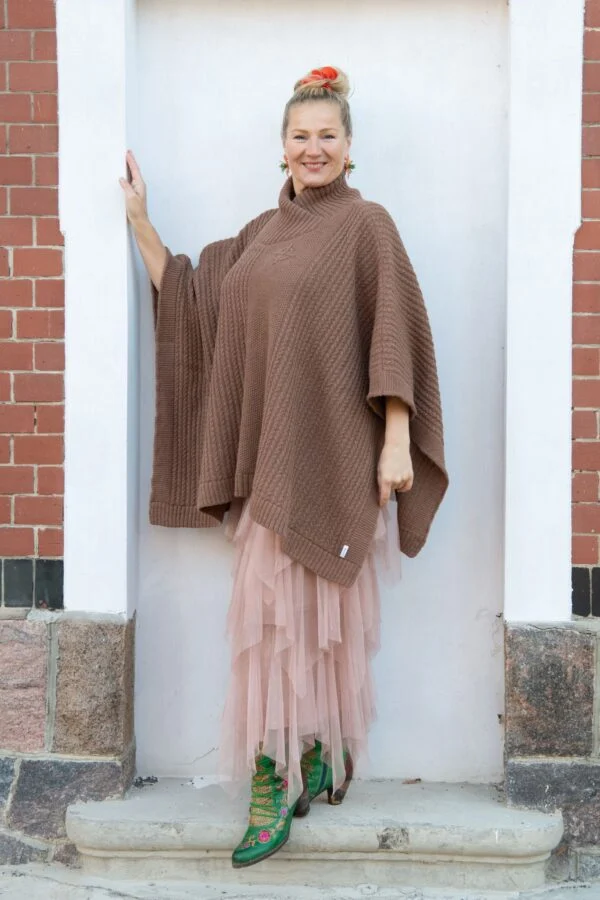 Poncho with fine cable pattern and protective symbol on chest