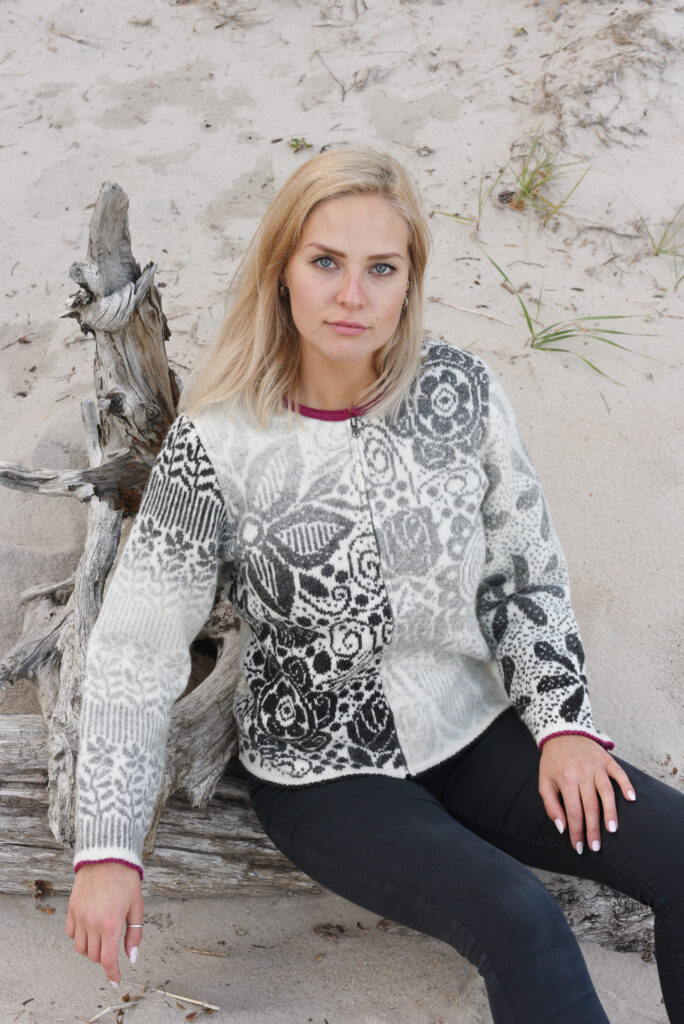 white female model wearing white wool cardigan with flowers