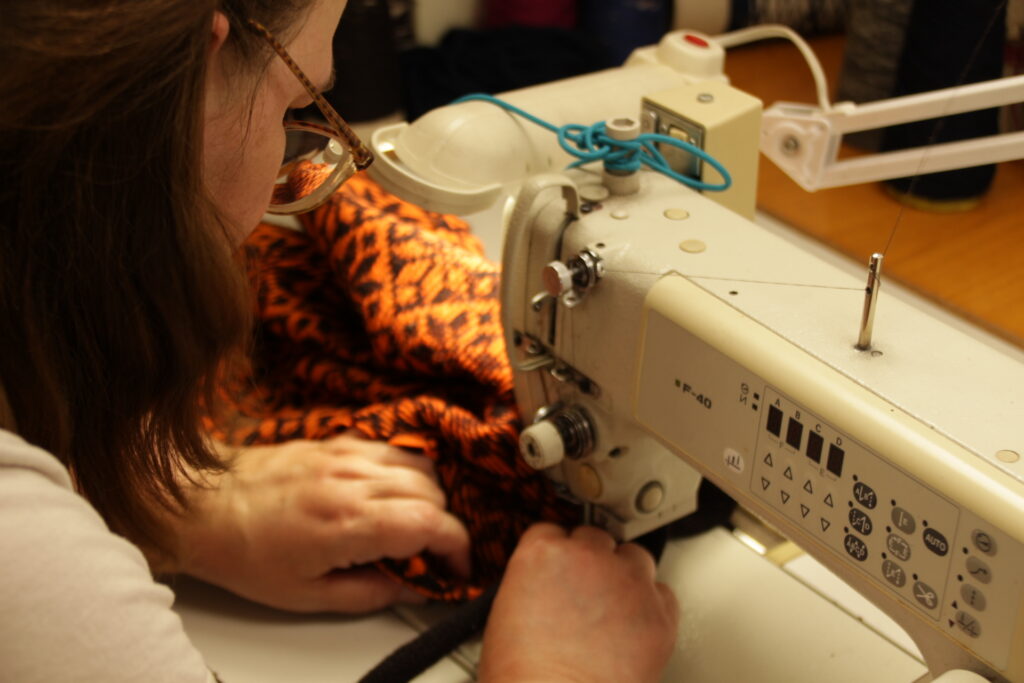 designer kauni sewing lady sewing an estonian pattern wool sweater
