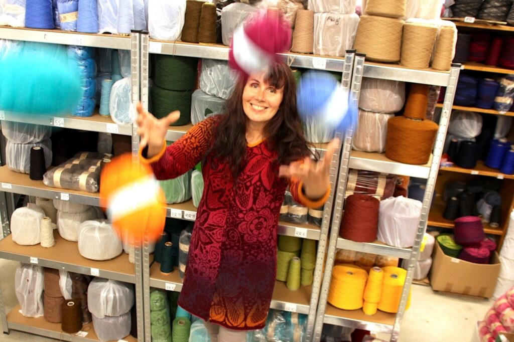 wool knitwear designer kauni throwing yarn skeins into the air