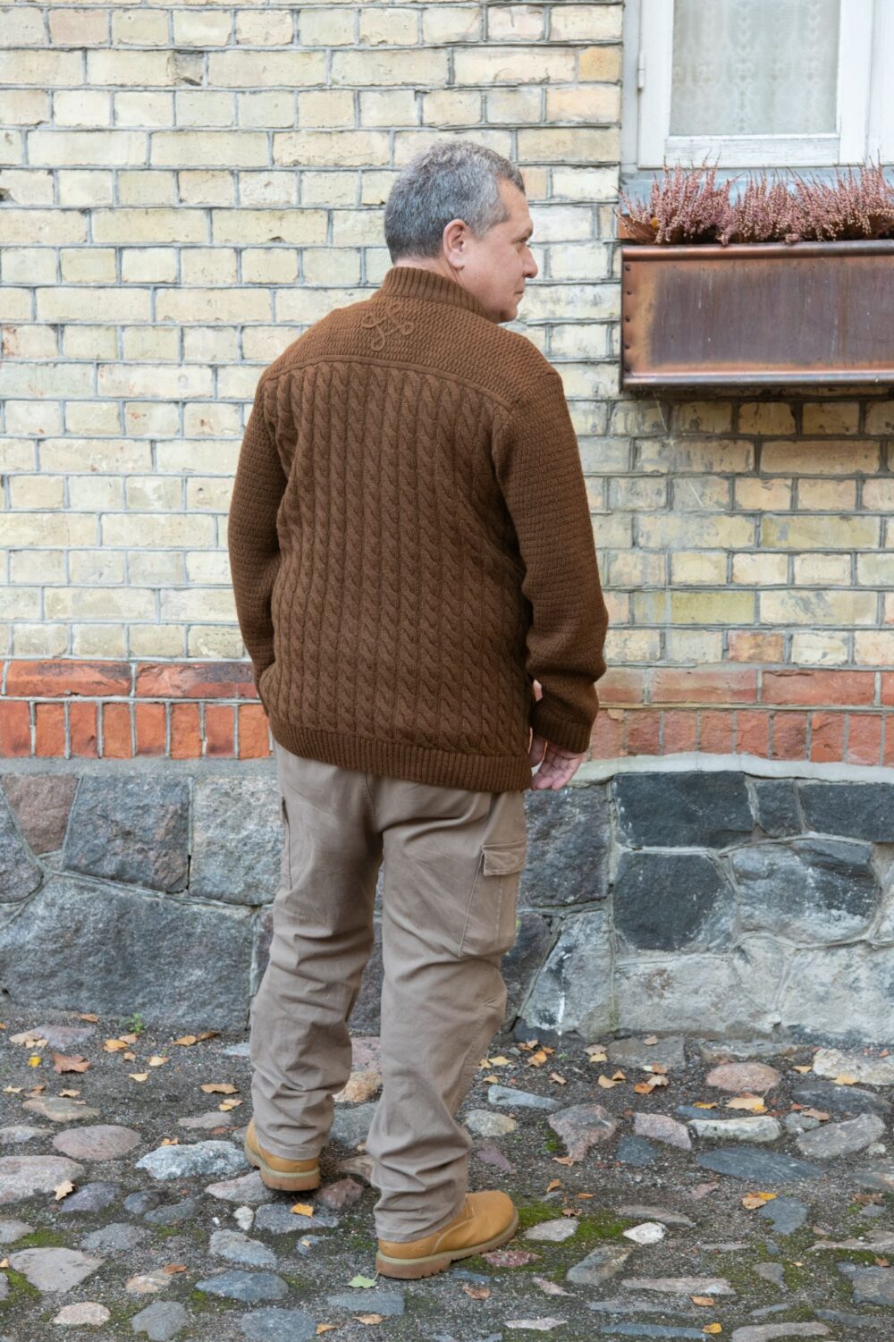 Men’s cardigan with cables, inner pockets, and power symbol on back - Image 2