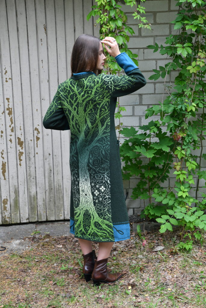 model wearing the kauni brand T-663 RR6 Long woolen coat with zipper and pockets, tree pattern on the back