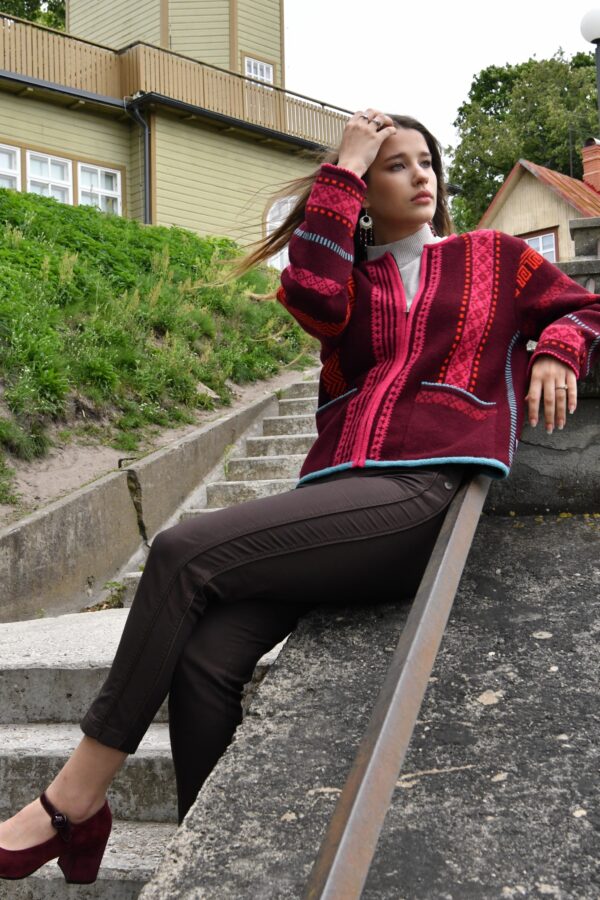 brunette model in short red wool cardigan from kauni design